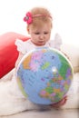 Baby girl search on world globe Royalty Free Stock Photo