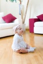 Baby girl seated on a floor