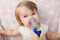 Baby girl sick and don`t want to use nebulizer mask making inhalation, respiratory procedure by pneumonia or cough for child Royalty Free Stock Photo