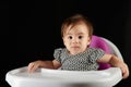 Baby girl sit on eating chair table Royalty Free Stock Photo