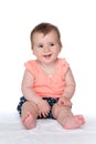 Baby girl sits on the white Royalty Free Stock Photo