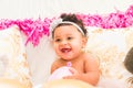 Baby Girl Sitting With Pillows and Balloons