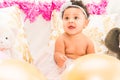 Baby Girl Sitting With Pillows and Balloons