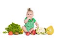 Baby girl sitting surrounded by fruits and vegetables, isolated on white Royalty Free Stock Photo