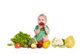 Baby girl sitting surrounded by fruits and vegetables, isolated on white Royalty Free Stock Photo