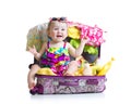 Baby girl sitting in trunk with things for Royalty Free Stock Photo