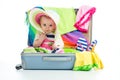 Baby girl sitting in trunk with things for vacation travel isolated Royalty Free Stock Photo