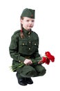 Baby girl sitting in uniform with red flowers, on white background