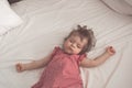 Baby girl sleeping on back with open arms and without pacifier in a bed with white sheets. Peaceful sleeping in a bright Royalty Free Stock Photo