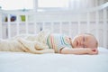 Baby girl sleeping in co-sleeper crib Royalty Free Stock Photo