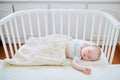 Baby girl sleeping in co-sleeper crib Royalty Free Stock Photo