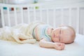 Baby girl sleeping in co-sleeper crib Royalty Free Stock Photo