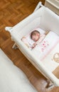 Baby girl sleeping in a cot with pacifier and toy Royalty Free Stock Photo