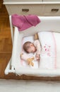 Baby girl sleeping in a cot with pacifier and toy Royalty Free Stock Photo
