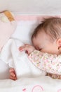 Baby girl sleeping in a cot with pacifier and toy Royalty Free Stock Photo