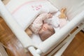 Baby girl sleeping in a cot with pacifier and toy Royalty Free Stock Photo