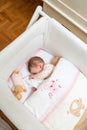 Baby girl sleeping in a cot with pacifier and toy Royalty Free Stock Photo