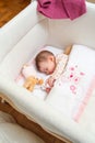 Baby girl sleeping in a cot with pacifier and toy Royalty Free Stock Photo