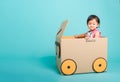 Baby girl smile in driving play car creative by a cardboard box Royalty Free Stock Photo