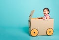 Baby girl smile in driving play car creative by a cardboard box Royalty Free Stock Photo