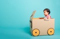 Baby girl smile in driving play car creative by a cardboard box Royalty Free Stock Photo