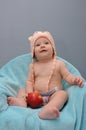 Baby girl smiles and hold the apple Royalty Free Stock Photo