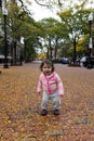 Baby Girl Smiling at Autumn Foliage Royalty Free Stock Photo