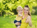 Baby girl and smiling mother pointing in camera Royalty Free Stock Photo