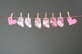 Baby girl socks and paper heart on the clothesline