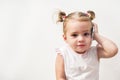 Baby girl speaking by cell phone, white background Royalty Free Stock Photo