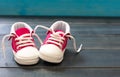 Baby girl pink shoes on blue color background, closeup view Royalty Free Stock Photo