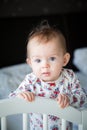 Baby girl standing in her bed Royalty Free Stock Photo