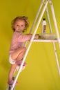 Baby girl on a step-ladder