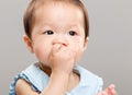 Baby girl sucking her finger into mouth Royalty Free Stock Photo