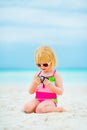 Baby girl in sunglasses with photo camera Royalty Free Stock Photo