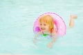 Baby girl with swim ring swimming in pool Royalty Free Stock Photo