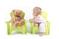 Baby Girl Talks with Her Toy Bear Royalty Free Stock Photo