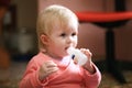 Baby girl toddler eats vitamins or pills at home