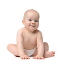 Baby girl toddler sitting in diaper looking at the camera Royalty Free Stock Photo