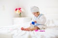 Baby girl in towel after bath. Infant care