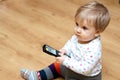 Baby girl with TV remote Royalty Free Stock Photo