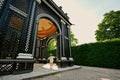 Baby girl under wooden arbor arch at Schonbrunn Palace in Vienna, Austria