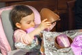 Baby girl unwrap chocolate easter egg newborn