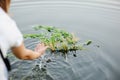 Baby girl walks on a river wreath of wild flowers Royalty Free Stock Photo