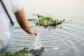 Baby girl walks on a river wreath of wild flowers Royalty Free Stock Photo