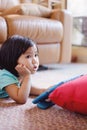 Baby girl watching television while holding tablet Royalty Free Stock Photo