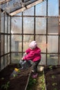 Baby girl watering from a watering can garden Royalty Free Stock Photo