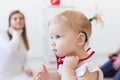 Baby girl wearing a hearing aid. Disabled child, disability and deafness concept. Royalty Free Stock Photo