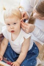 Baby girl wearing a hearing aid. Disabled child, disability and deafness concept.