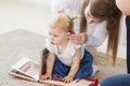 Baby girl wearing a hearing aid. Disabled child, disability and deafness concept.